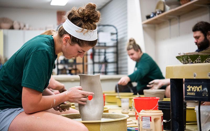 A student working in Ceramics class.